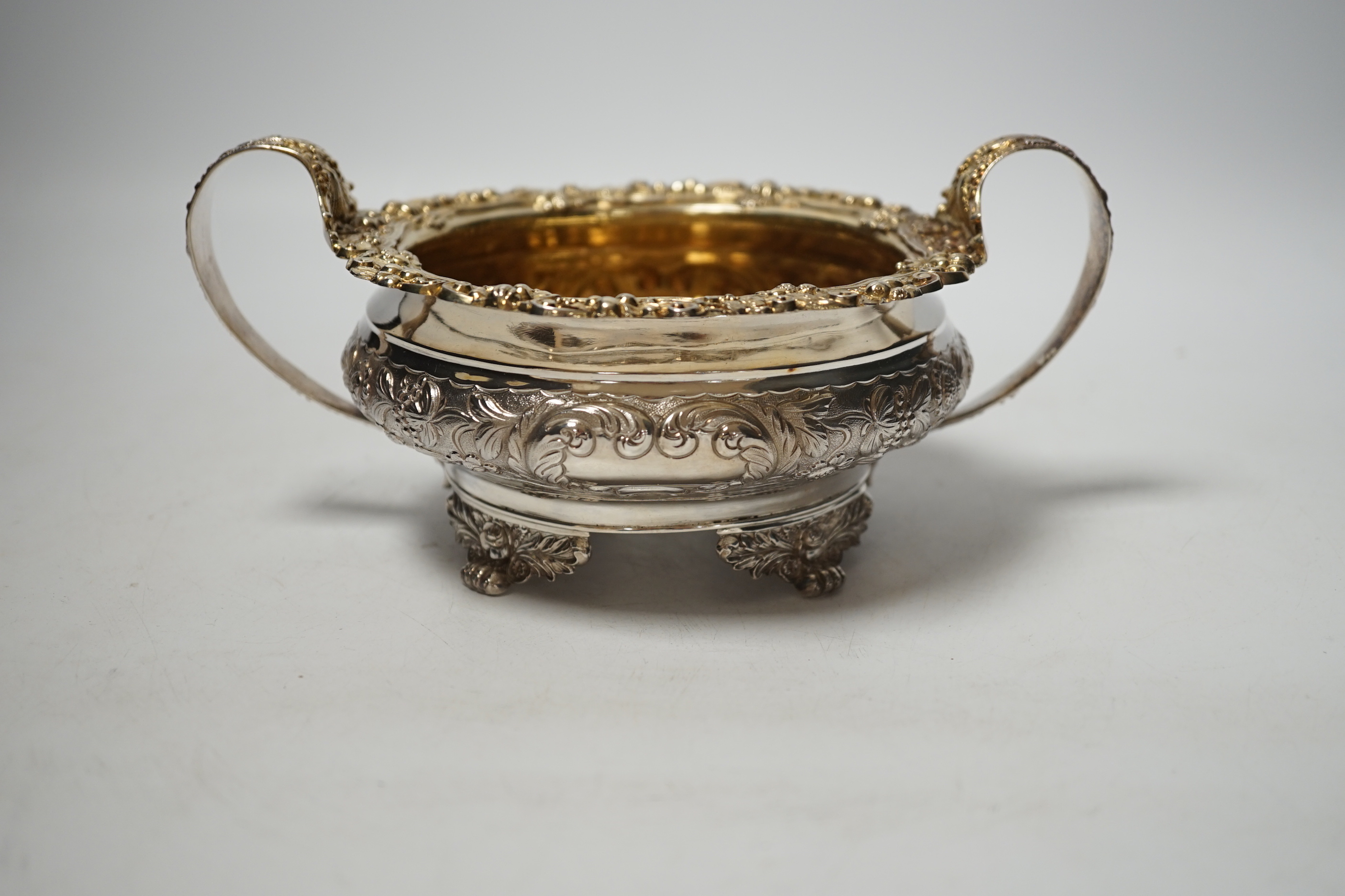 A George IV embossed silver two handled sugar bowl, Thomas James, London, 1822, diameter 14.7cm, 12.7oz.